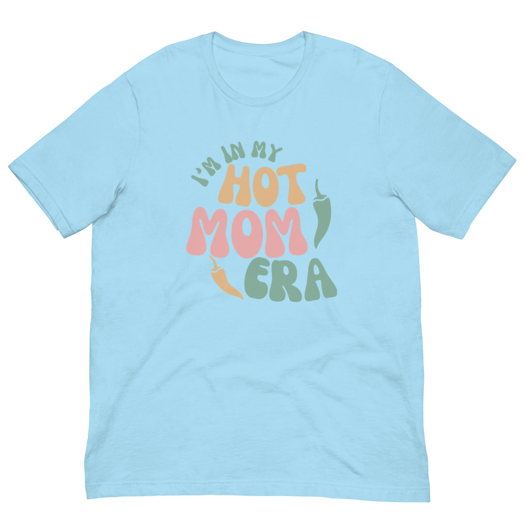 A light blue combed cotton Era Shirt with the phrase "i'm in my hot mom era" printed in colorful, playful lettering on the front.