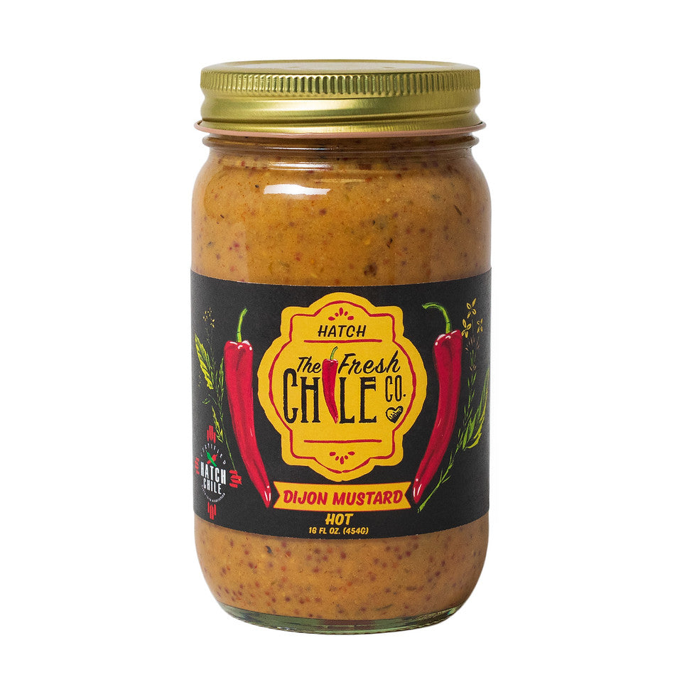 A glass jar of **The Fresh Chile Co. Hatch Chile Dijon Mustard** with a yellow cap, labeled "The Fresh Chile Co." and featuring images of red chili peppers, on a white background.