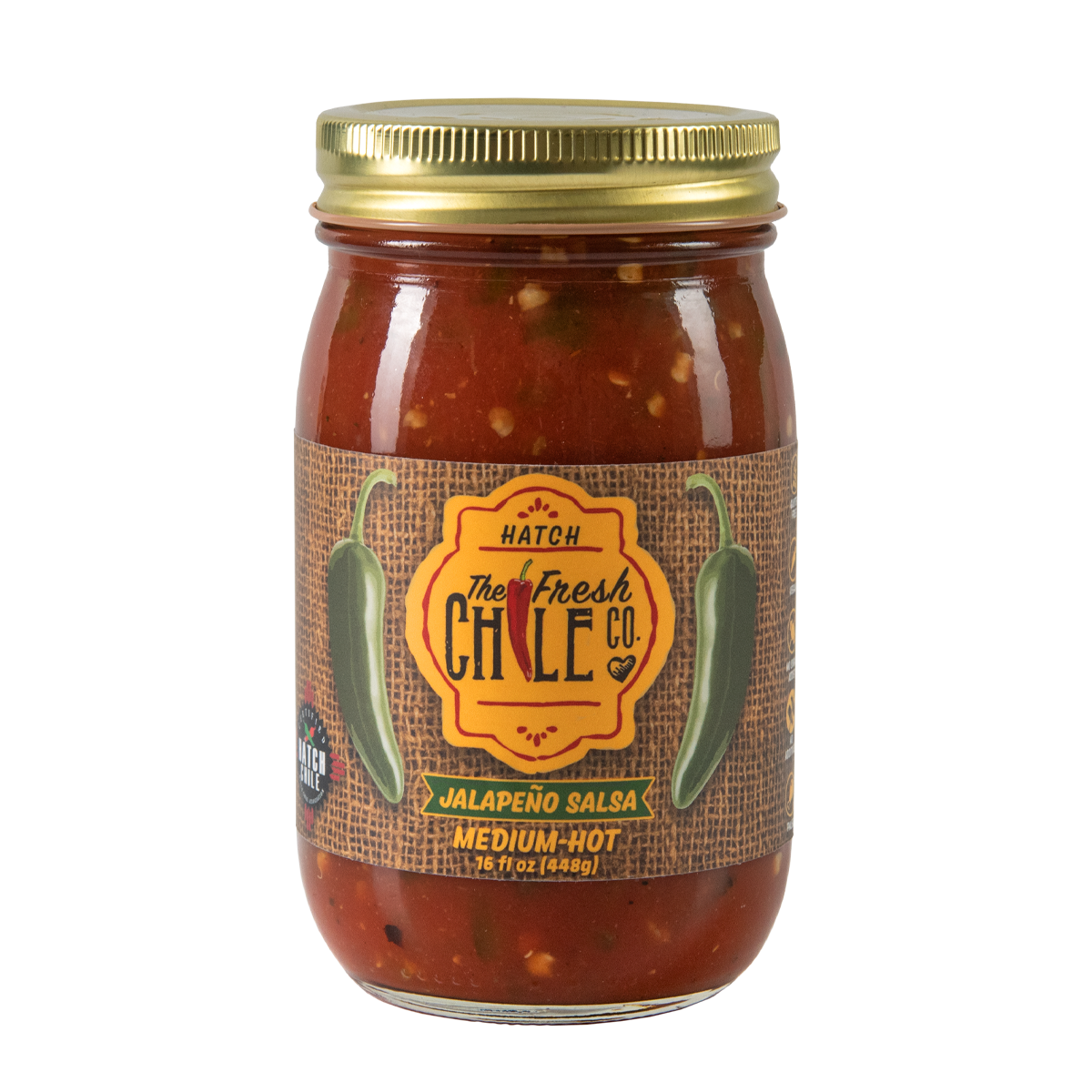 A glass jar of Hatch Jalapeño Salsa labeled "The Fresh Chile Co. Hatch" in medium-hot spiciness, sealed with a metal lid, isolated on a white background. Perfect for New Mexican salsa recipes.