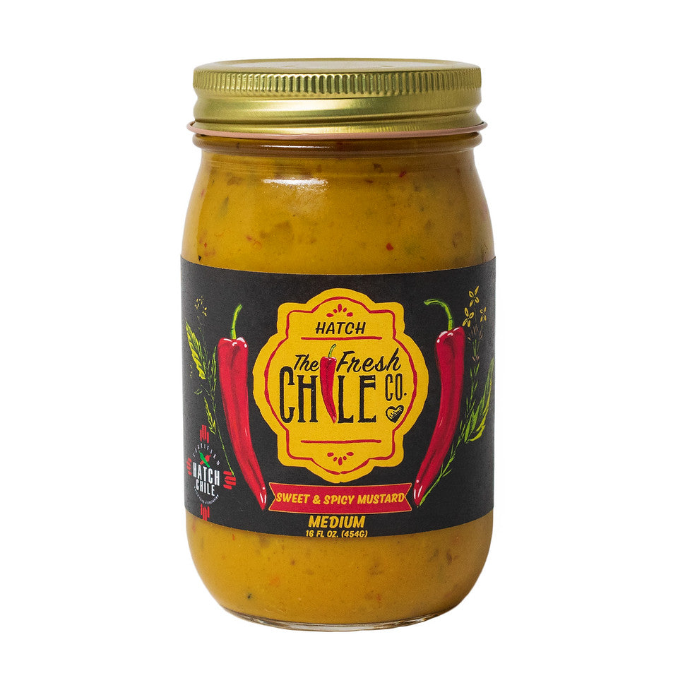 A jar of Sweet & Spicy Hatch Chile Mustard, sweet & spicy with a medium heat level, featuring red chilies and black text on the label, isolated on a white background.
