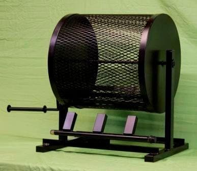 A Medium Table Top Roaster with a crank, mounted on a stand, in front of a green background. Three pink tickets are visible in slots near the Fresh Hatch Green Chile.